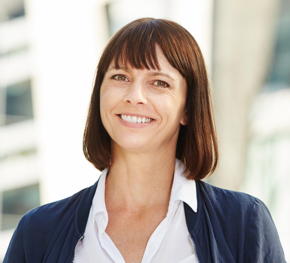 Closeup,Portrait,Of,Smiling,Middle,Aged,Woman,Standing,Outside
